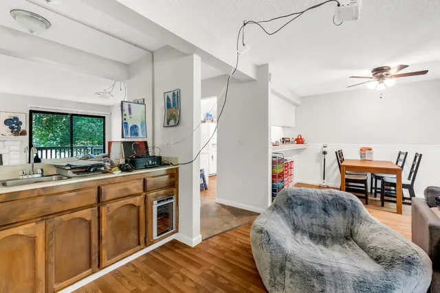 a living room with furniture a dining table and a fireplace