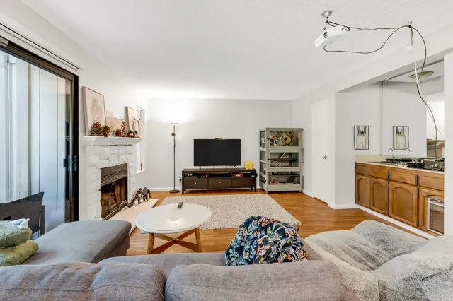 a living room with furniture fireplace and flat screen tv
