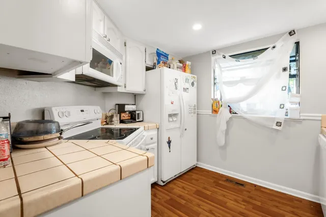 a kitchen with stainless steel appliances a stove a refrigerator and cabinets