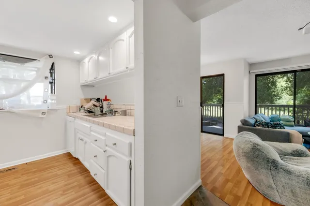 a living room with kitchen island furniture and a wooden floor
