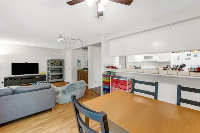 a living room with stainless steel appliances kitchen island granite countertop furniture and a kitchen view