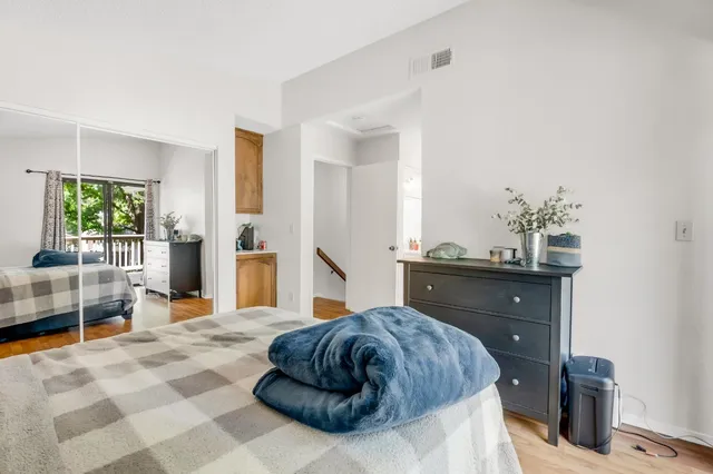 a bedroom with a bed and a large window