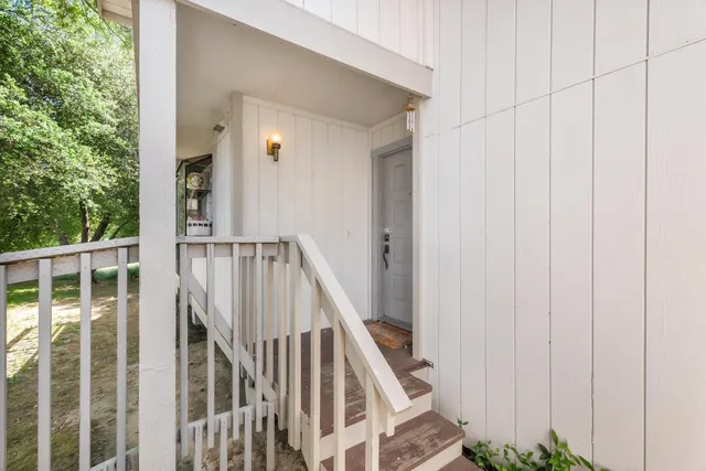 a view of staircase with railing and white walls