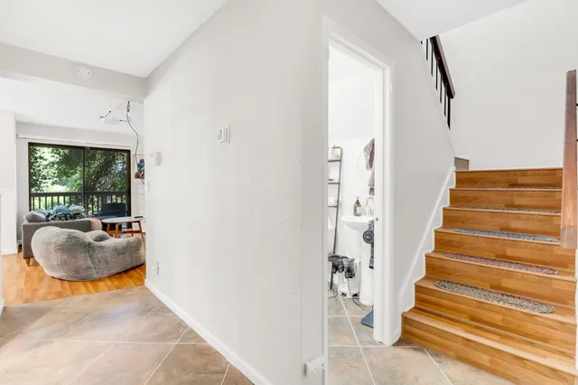 a view of entryway and hall with wooden floor
