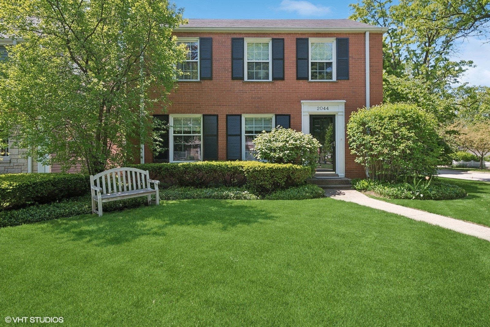 a front view of a house with a garden