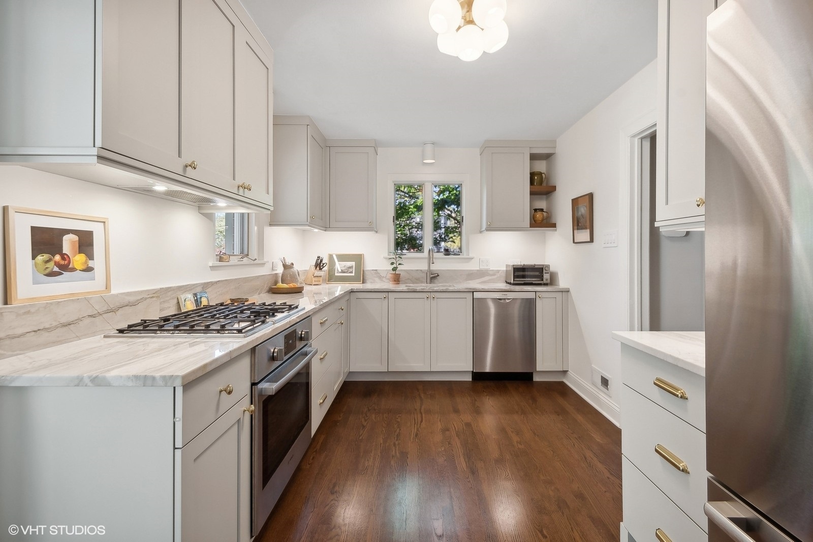 2044 Ewing Avenue Evanston, IL 60201 - Photo 13 of 35 a kitchen with a sink cabinets stainless steel appliances and a window