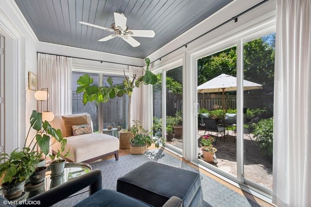 a living room with patio furniture and a garden