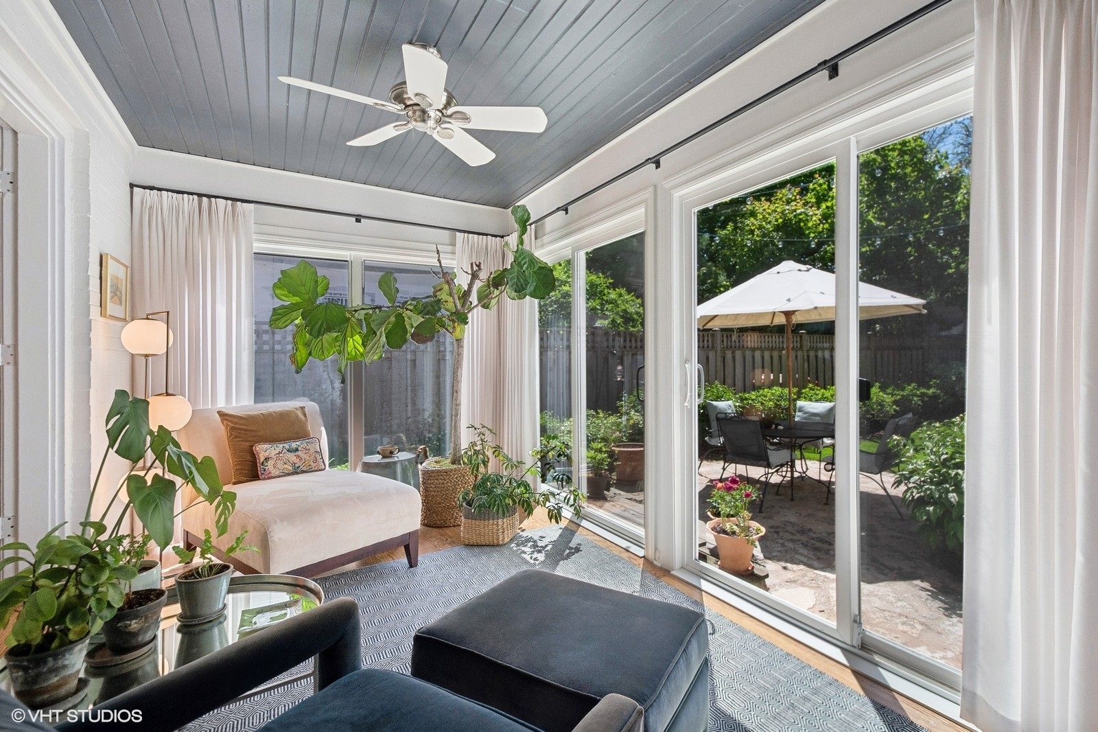 2044 Ewing Avenue Evanston, IL 60201 - Photo 17 of 35 a living room with patio furniture and a garden