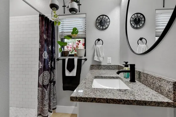 a table with a clock on the wall and a sink