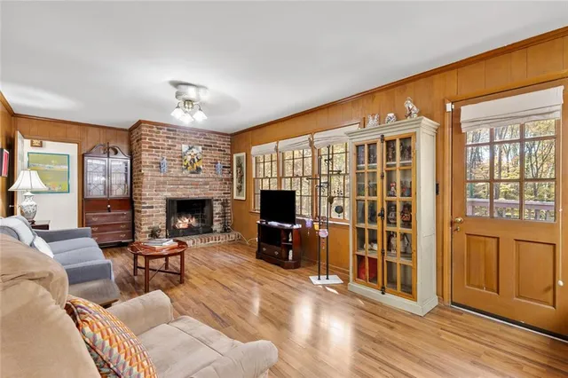 a living room with furniture a fireplace and a flat screen tv