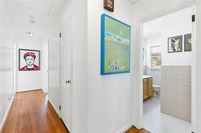 a view of hallway with wooden floor and stairs