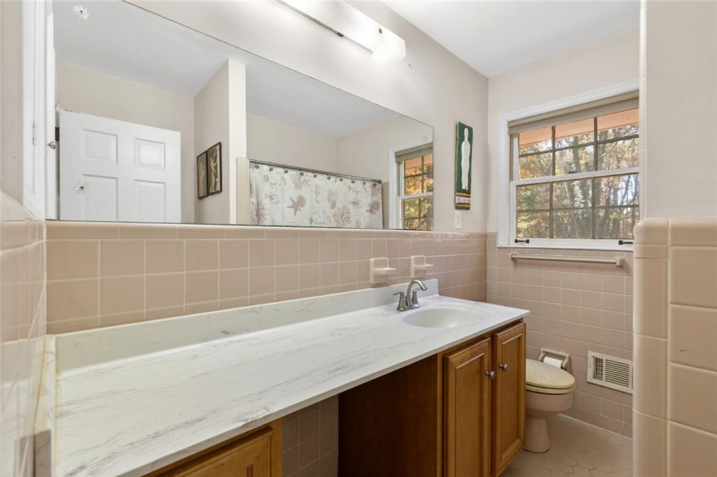 2258 Greencrest Drive Northeast Atlanta, GA 30345 - Photo 17 of 39 a bathroom with a sink a toilet and shower