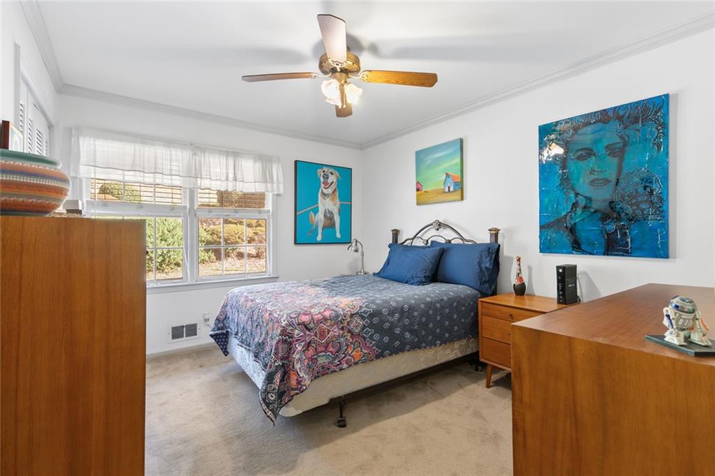 2258 Greencrest Drive Northeast Atlanta, GA 30345 - Photo 18 of 39 a bedroom with a bed and a painting on the wall