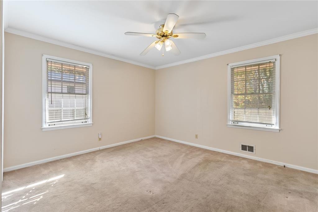 2258 Greencrest Drive Northeast Atlanta, GA 30345 - Photo 19 of 39 an empty room with windows and fan