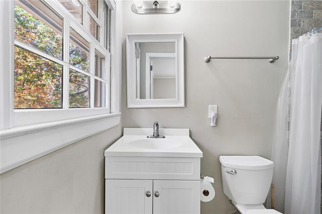 2258 Greencrest Drive Northeast Atlanta, GA 30345 - Photo 21 of 39 a bathroom with a toilet sink and mirror