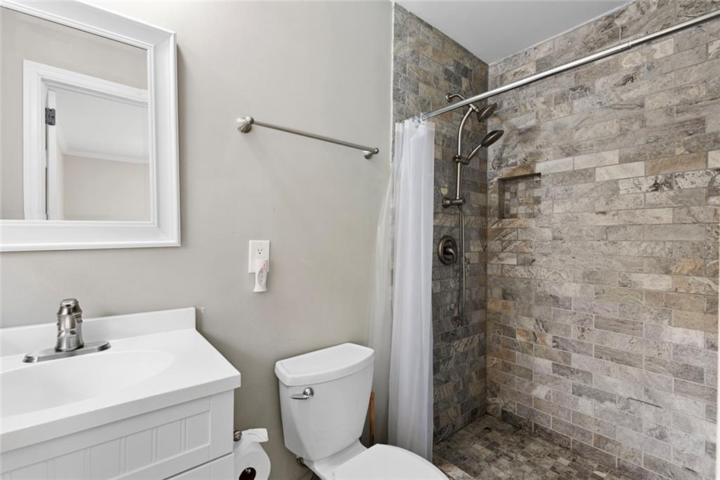 2258 Greencrest Drive Northeast Atlanta, GA 30345 - Photo 22 of 39 a bathroom with a sink a toilet and shower