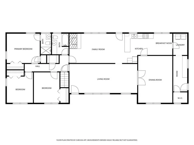 a picture of a room with a white wall and white refrigerator