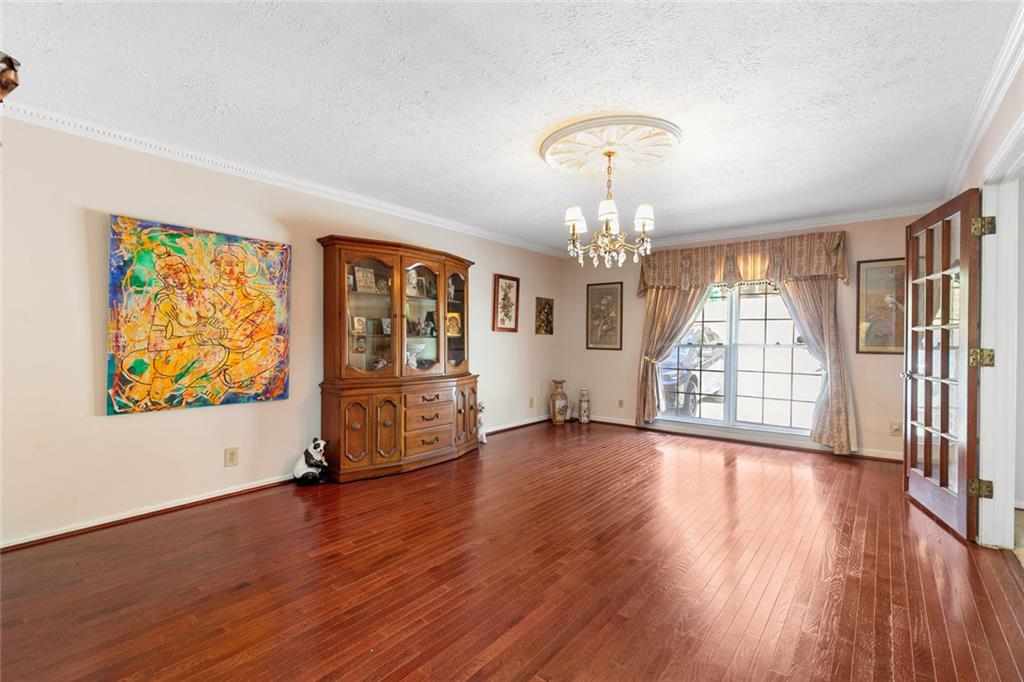 2258 Greencrest Drive Northeast Atlanta, GA 30345 - Photo 5 of 39 wooden floor in an empty room with a window