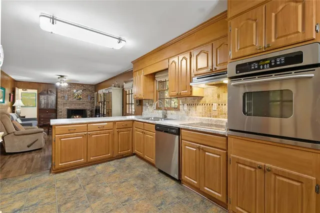 a kitchen with stainless steel appliances granite countertop a sink and cabinets
