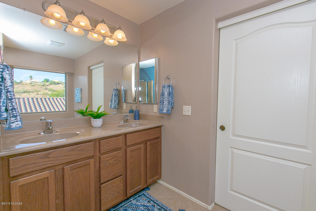 39103 Winners Circle Tucson, AZ 85739 - Photo 7 of 19 a bathroom with a sink a light fixture and a mirror