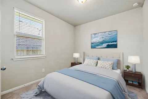 a bedroom with a bed and a painting on the wall