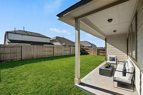 a view of a backyard with wooden fence