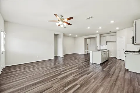 a view of a kitchen with wooden floor and a kitchen island