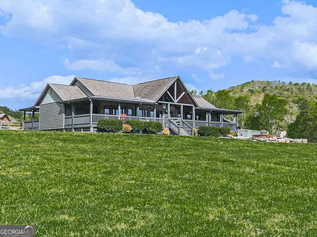 a bedroom with a bed and large windows