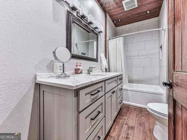 a view of a kitchen with a stove top oven and cabinets