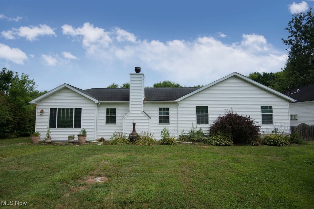 4594 Center Road Andover, OH 44003 - Photo 1 of 39 Front view of house with a chimney, a yard, and roof with shingles