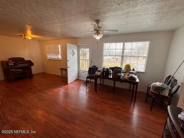 a living room with a bed and a chandelier