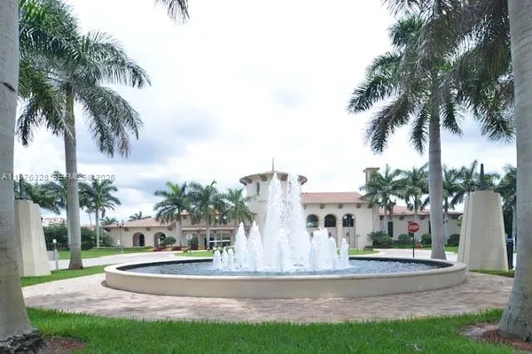 a view of a patio with table and chairs plants and palm trees