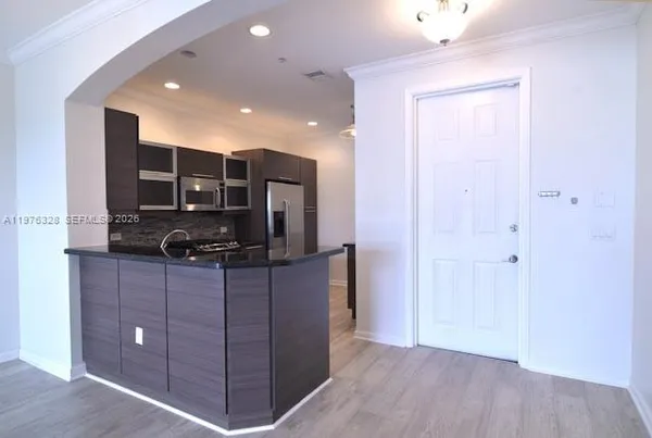 a view of a kitchen with a sink and a fireplace