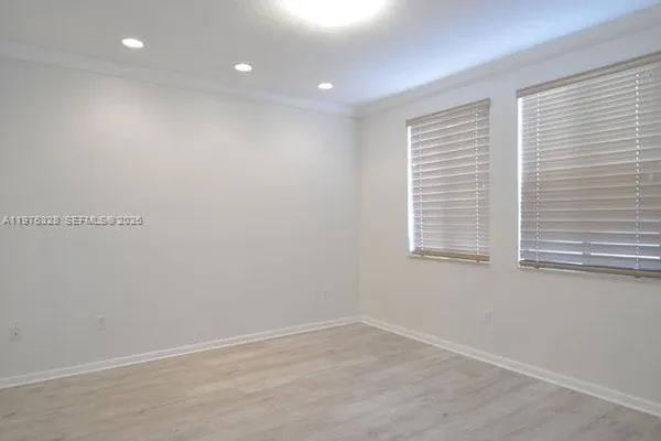 a living room with gym equipment and a large window