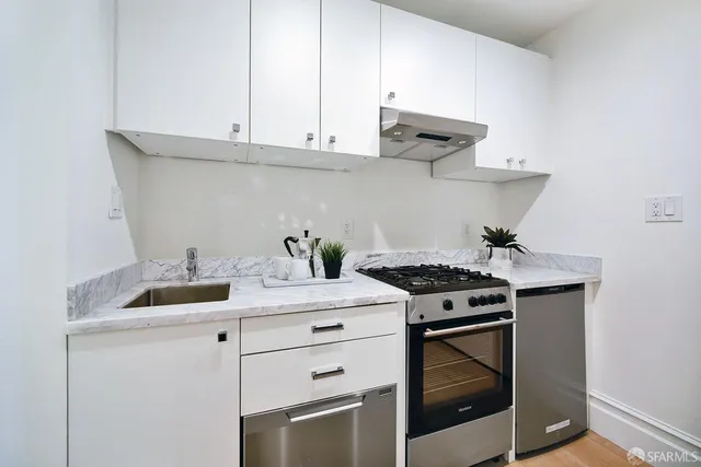 a stove top oven sitting inside of a kitchen