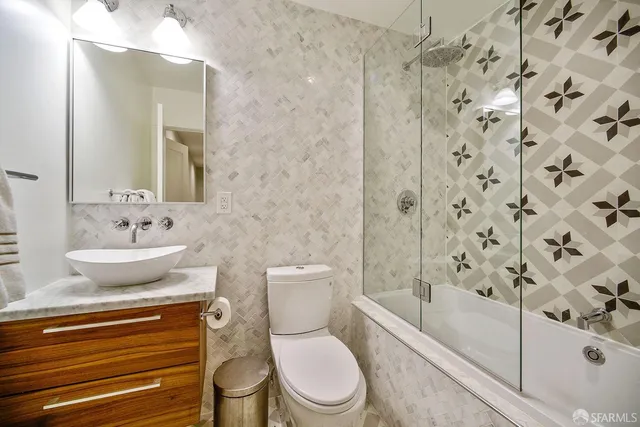 a bedroom with a bed and painting on the wall