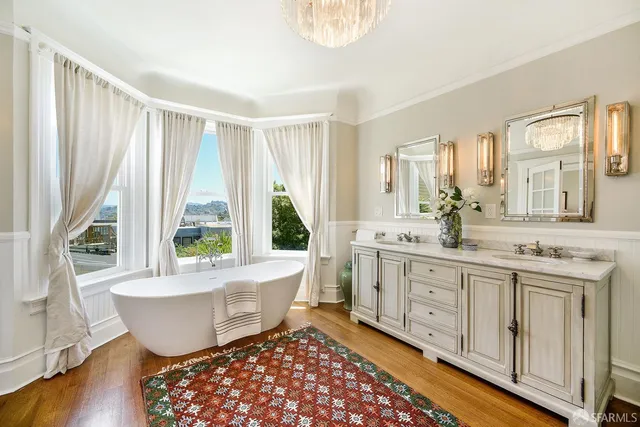 a hallway with painting on the wall and a window