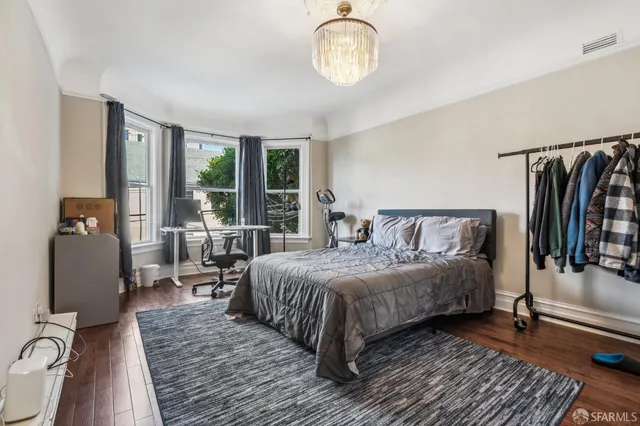 a spacious bathroom with double vanity a window a mirror and a bathtub