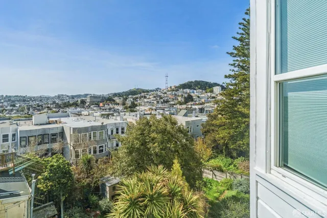 a kitchen with refrigerator and cabinets