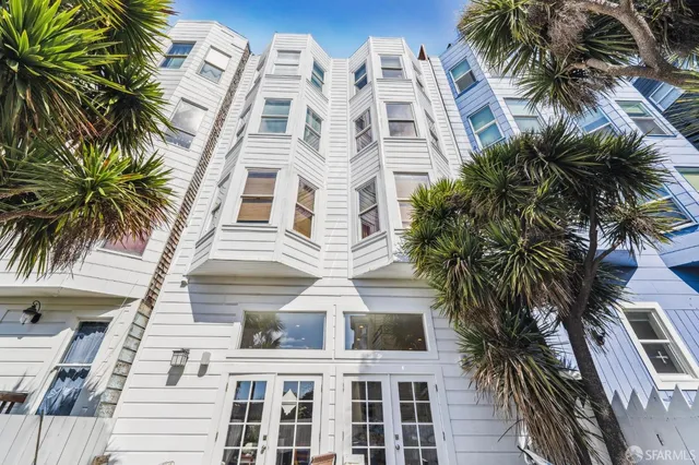 a bedroom with bed and a large window