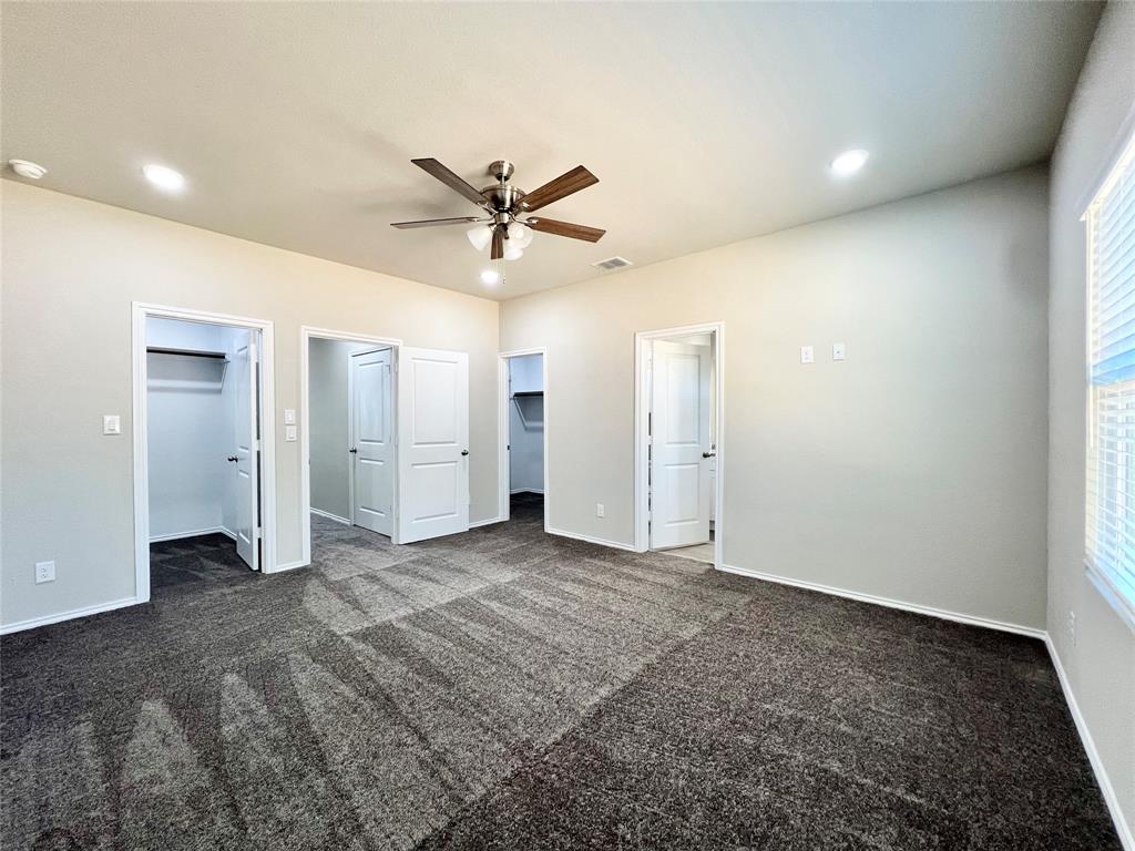 3501 East Renfro Street, Unit 120 Burleson, TX 76028 - Photo 23 of 30 an empty room with closet and a ceiling fan