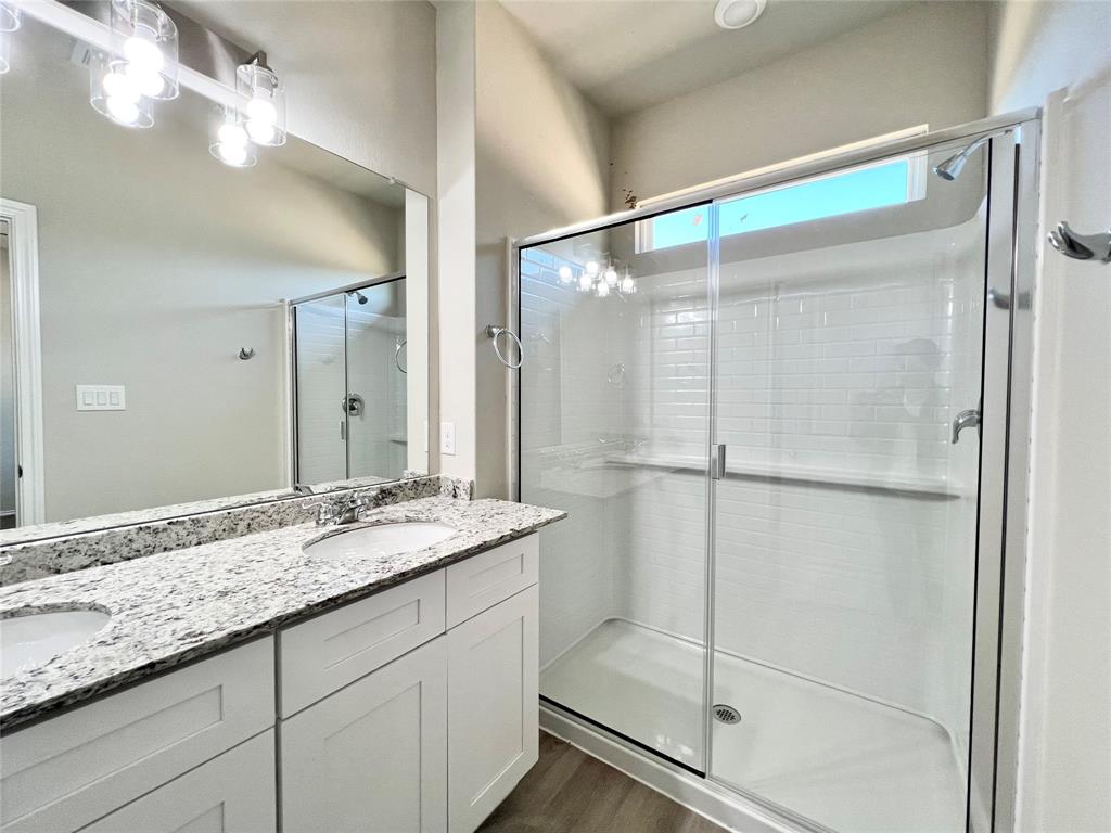 3501 East Renfro Street, Unit 120 Burleson, TX 76028 - Photo 26 of 30 a bathroom with a granite countertop shower sink and mirror
