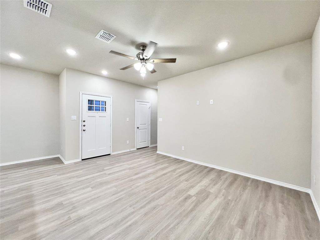 3501 East Renfro Street, Unit 120 Burleson, TX 76028 - Photo 4 of 30 wooden floor in an empty room with a window