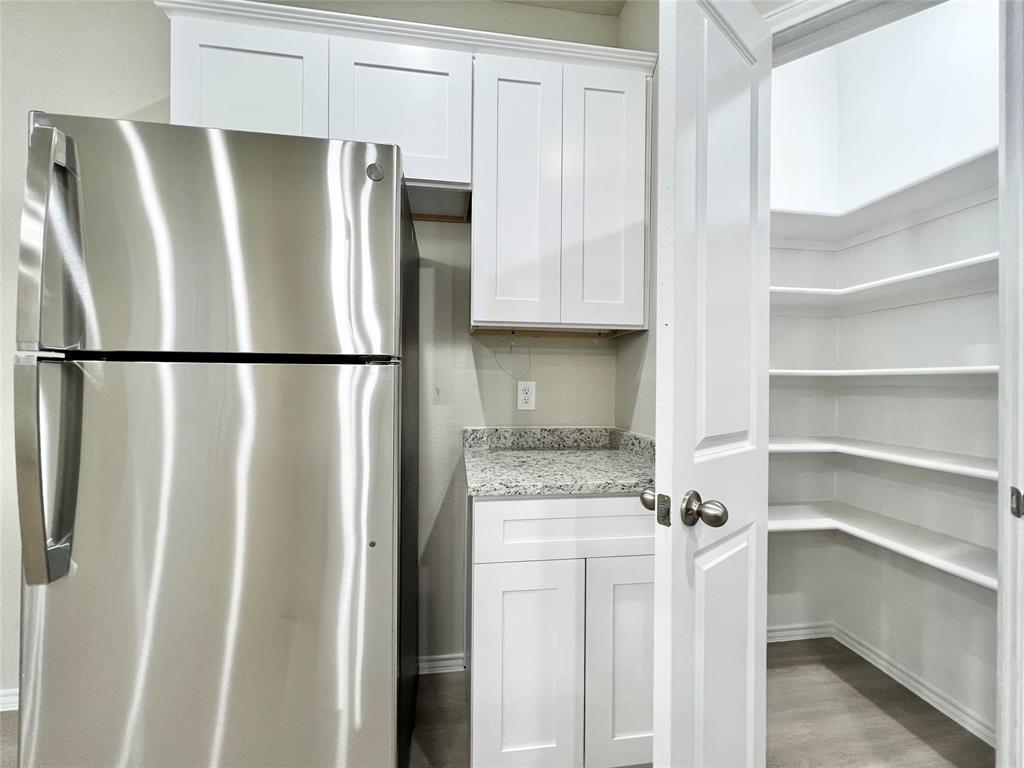 3501 East Renfro Street, Unit 120 Burleson, TX 76028 - Photo 6 of 30 a white refrigerator freezer sitting in a kitchen