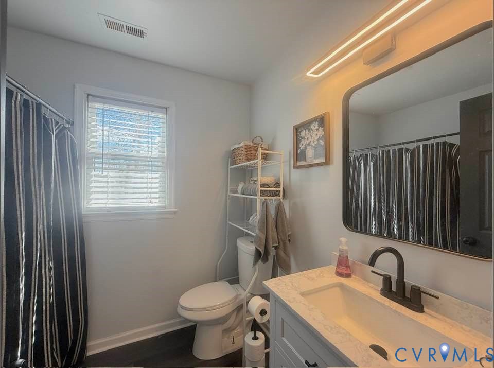 6009 Simplicity Court Chesterfield, VA 23832 - Photo 16 of 22 a bathroom with a toilet sink and mirror