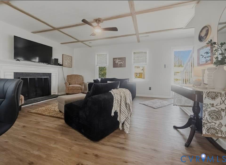 6009 Simplicity Court Chesterfield, VA 23832 - Photo 10 of 22 a living room with furniture a fireplace and a flat screen tv