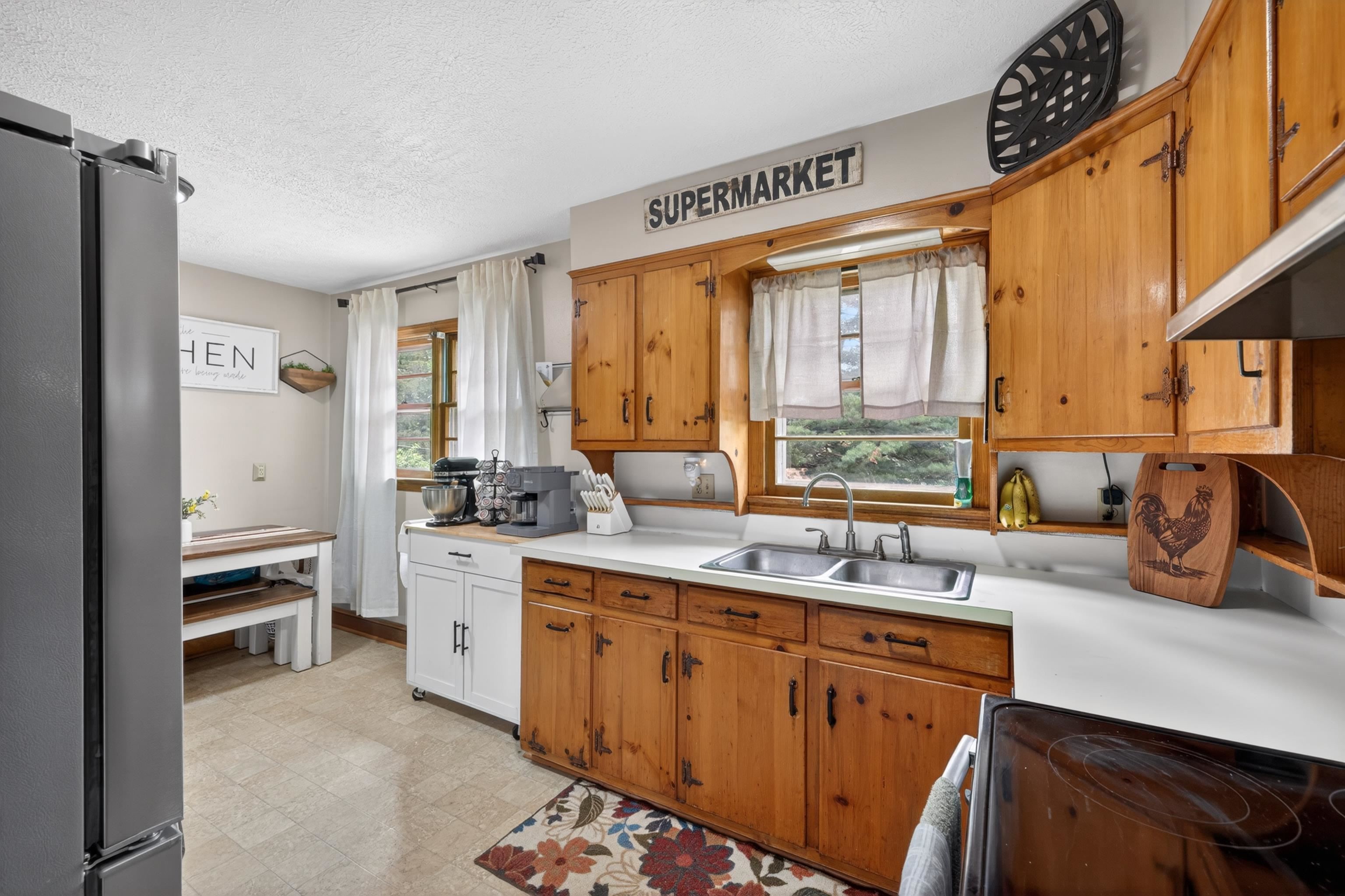 7827 Lee Highway Raphine, VA 24472 - Photo 26 of 62 a kitchen with stainless steel appliances a sink stove and a refrigerator