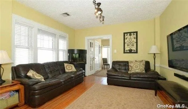 a living room with furniture window and a flat screen tv