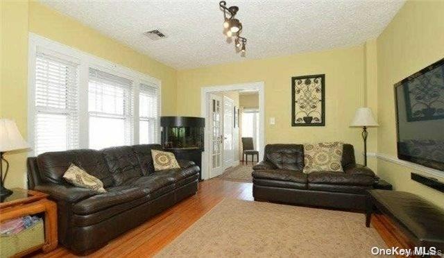 31 Highland Court Huntington, NY 11743 - Photo 4 of 12 a living room with furniture window and a flat screen tv
