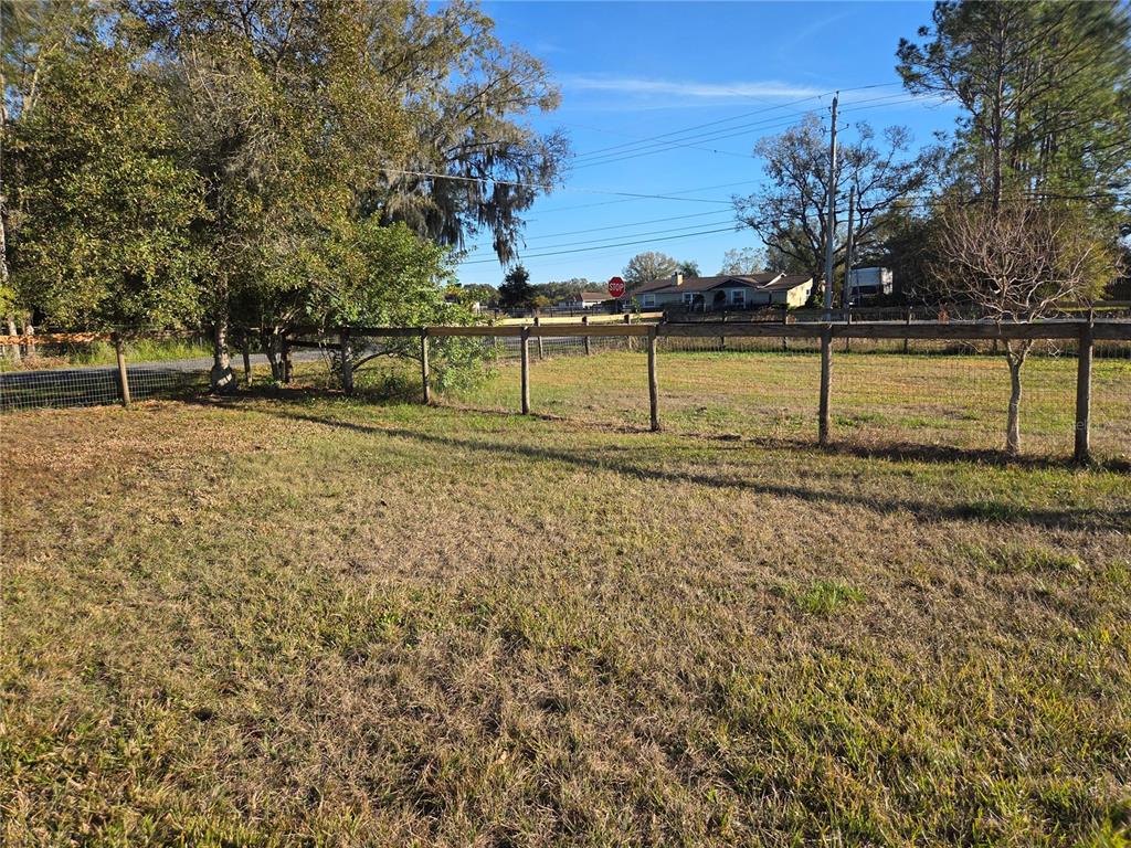 4901 North Vaughn Road Plant City, FL 33565 - Photo 26 of 31 a view of a yard with wooden fence